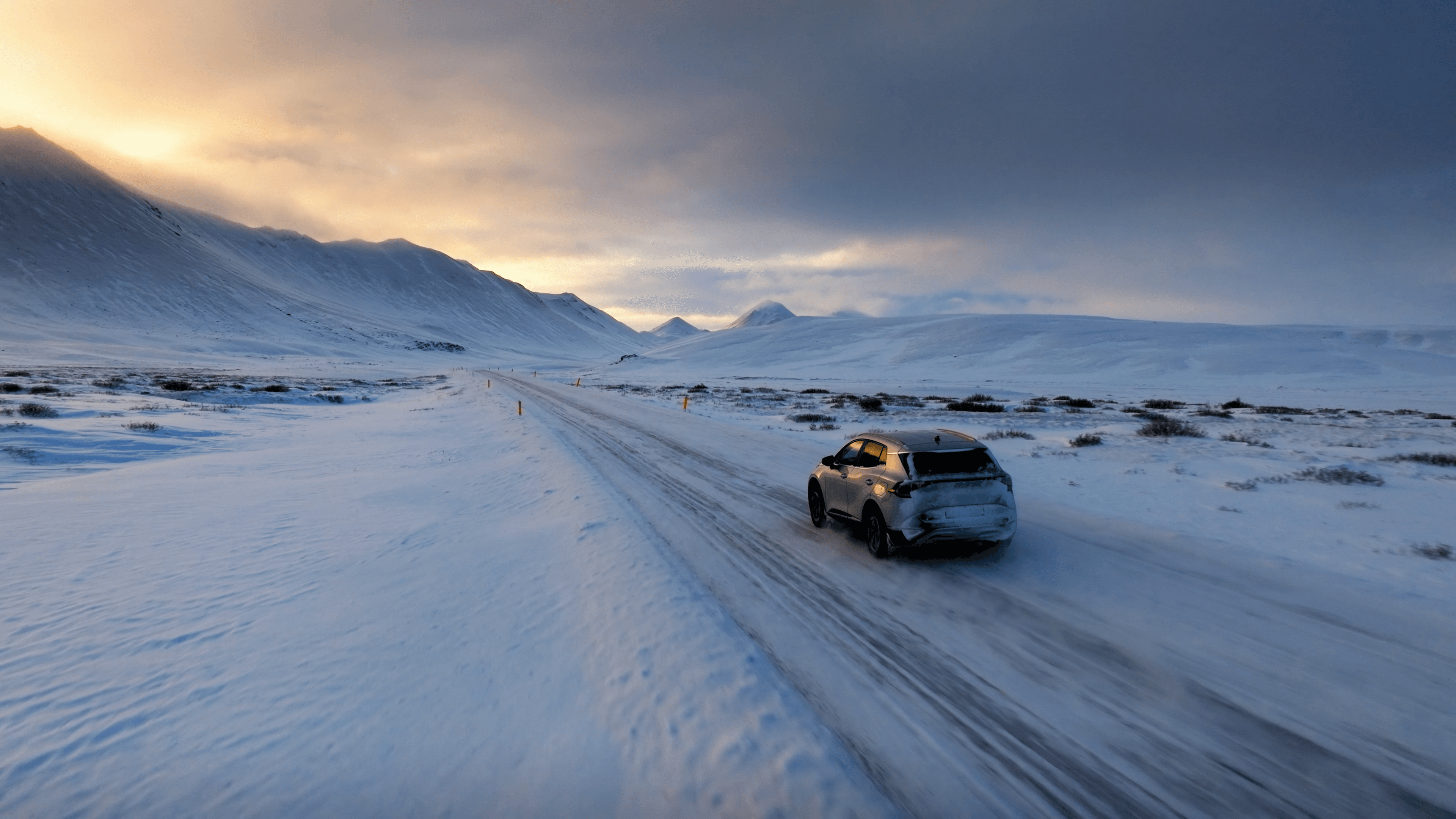 A vehicle traverses the Arctic tundra at dusk